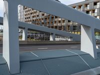 an overpass in a building next to street lights and a traffic signal on it