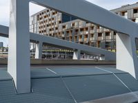 an overpass in a building next to street lights and a traffic signal on it