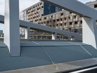 an overpass in a building next to street lights and a traffic signal on it