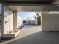 a white bathroom with the tile floor and walls covered in white marble tiles and benches