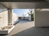 a white bathroom with the tile floor and walls covered in white marble tiles and benches