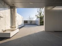 a white bathroom with the tile floor and walls covered in white marble tiles and benches