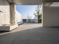 a white bathroom with the tile floor and walls covered in white marble tiles and benches