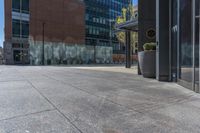 a fire hydrant in front of an office building with glass doors and windows on a sunny day