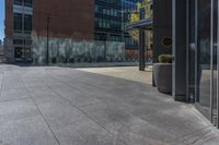 a fire hydrant in front of an office building with glass doors and windows on a sunny day