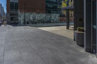 a fire hydrant in front of an office building with glass doors and windows on a sunny day