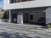 the exterior and landscape of a modern house in los angeles, california with stone and wood