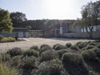 a picture of a very nice house on a hill side by the ocean from a little place near the water