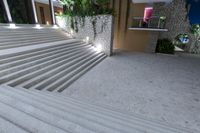 a bunch of white stairs leading up to an entrance of a building with large windows