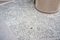 there is a square bathroom floor with a round tiled floor and tiled shower stall in the foreground