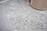 there is a square bathroom floor with a round tiled floor and tiled shower stall in the foreground