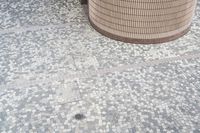 there is a square bathroom floor with a round tiled floor and tiled shower stall in the foreground