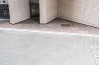 there is a square bathroom floor with a round tiled floor and tiled shower stall in the foreground