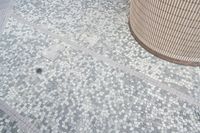 there is a square bathroom floor with a round tiled floor and tiled shower stall in the foreground