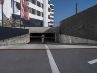 a parking garage with flag hanging on a wall above it and an empty parking space on the right side