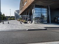 a large building that has a metal structure near it's entrance with windows and doors