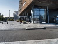 a large building that has a metal structure near it's entrance with windows and doors