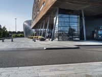 a large building that has a metal structure near it's entrance with windows and doors