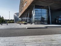 a large building that has a metal structure near it's entrance with windows and doors