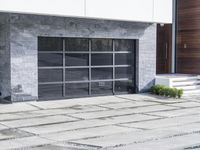 the exterior and landscape of a modern house in los angeles, california with stone and wood