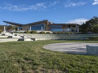 a large house with concrete steps leading to a lawn area outside of the building and stairs are set up next to the grass