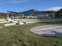 a large house with concrete steps leading to a lawn area outside of the building and stairs are set up next to the grass