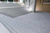 white stone steps and cement railings outside of a house with plants growing on it