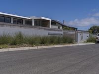 the home has been built into this wall with an attached balcony that overlooks the ocean