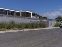 the home has been built into this wall with an attached balcony that overlooks the ocean