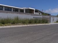 the home has been built into this wall with an attached balcony that overlooks the ocean