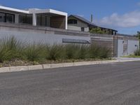 the home has been built into this wall with an attached balcony that overlooks the ocean