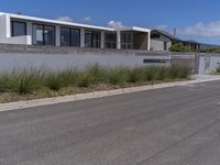 the home has been built into this wall with an attached balcony that overlooks the ocean