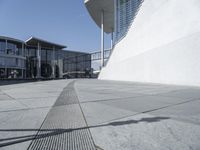 a view of the water's edge of the building while someone in the distance walks along