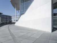 a view of the water's edge of the building while someone in the distance walks along