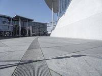 a view of the water's edge of the building while someone in the distance walks along