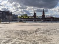 a body of water near some buildings and people on a bench in front of it