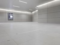 a white floor has tile and lights lit by recesses in an empty room on the wall