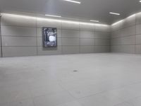 a white floor has tile and lights lit by recesses in an empty room on the wall