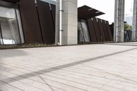 a sidewalk leading up to a building with a few columns and walkways that lead up to it