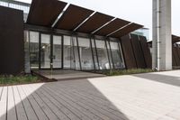 a sidewalk leading up to a building with a few columns and walkways that lead up to it