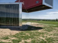 a container hanging upside down outside of the house in its enclosure, for protection of mosquito