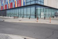 a red stop sign is at the end of an empty sidewalk and outside a building