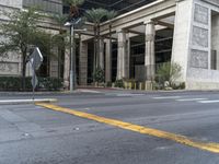 there is a tall building with columns on it's sides and a parking meter in the front