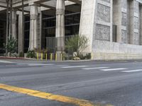 there is a tall building with columns on it's sides and a parking meter in the front