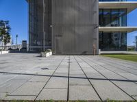 a building with a parking meter on the pavement next to it and some grass on both sides