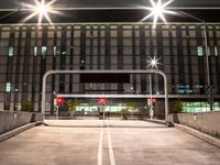 a car is parked under streetlights and a parking garage for cars with no passengers