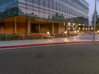 two grey blocks sitting next to a tall building on a sidewalk in front of grass