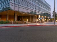 two grey blocks sitting next to a tall building on a sidewalk in front of grass