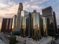 the buildings in the city are near the highway by it are tall with a lot of glass and concrete