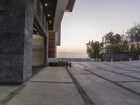 the exterior and landscape of a modern house in los angeles, california with stone and wood